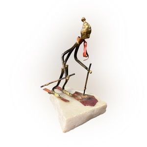 SMALL METAL SCULPTURE ON STONE